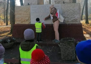 Dzieci wykonują zadania podczas gry terenowej.