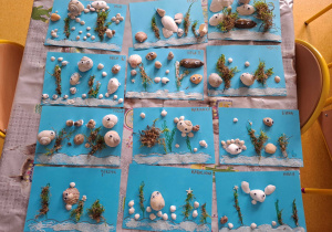 Prace plastyczne wykonane z muszelek, mchu i piasku