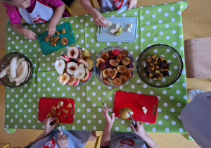 Dzieci kroją owoce na sałatkę